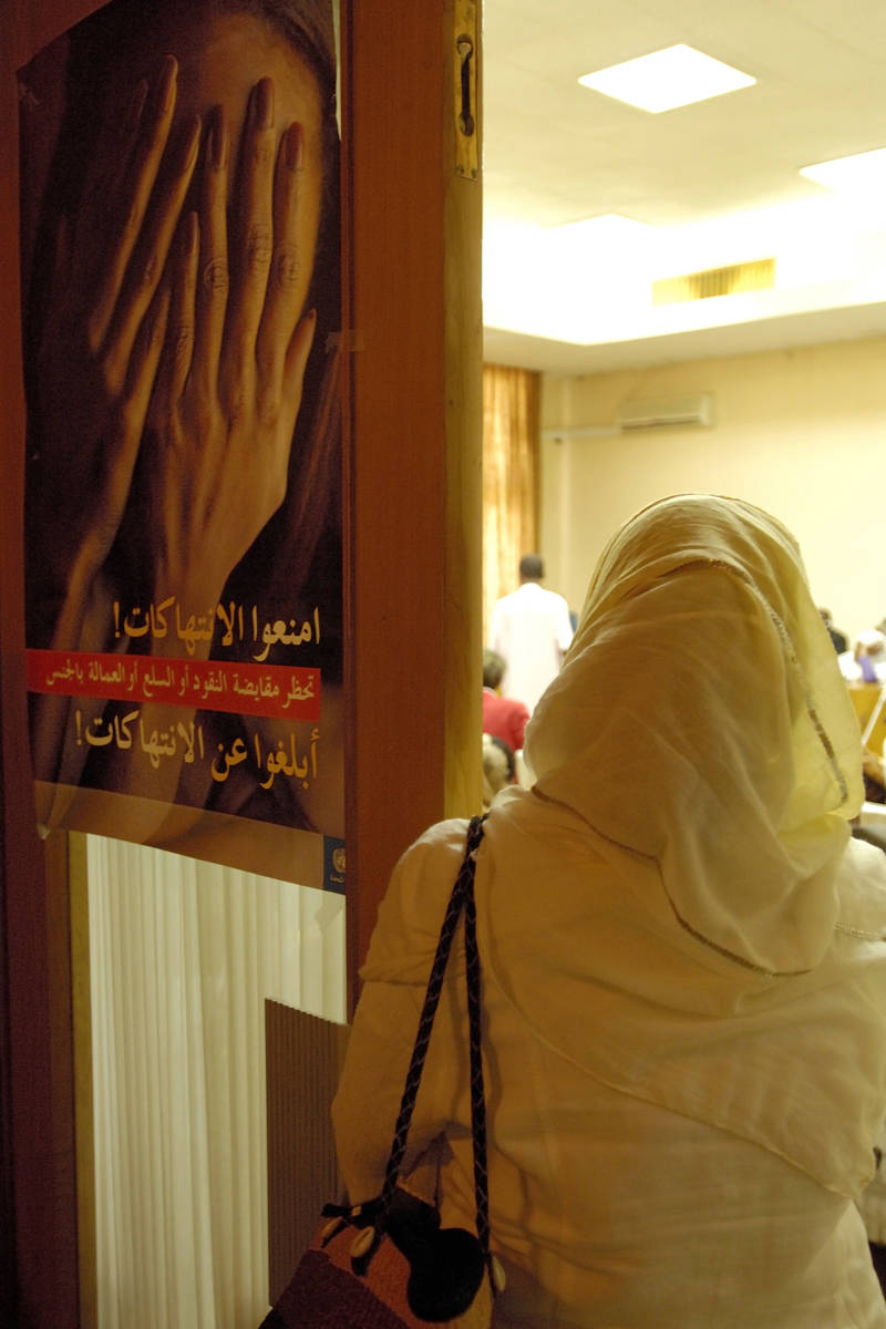 A woman stands next to an anti Sexual Exploitation and Abuse (SEA) poster during a one-day workshop hosted by the National Council on Child Welfare, in Khartoum, Sudan. UN Photo/Fred Noy
